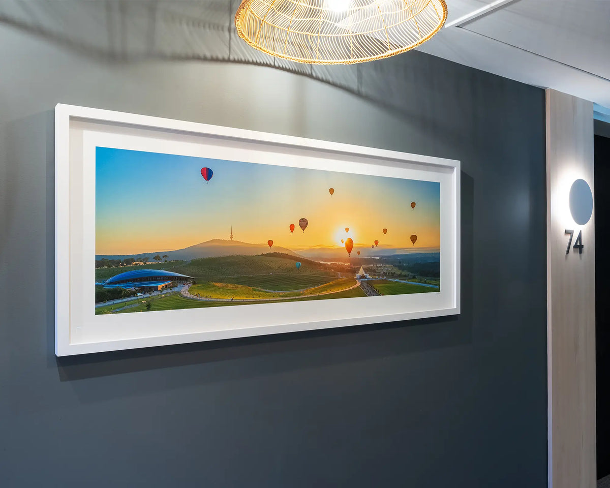 Balloon Sunrise. Balloon Spectacular, National Arboretum Canberra, with white frame on grey wall in apartment building.