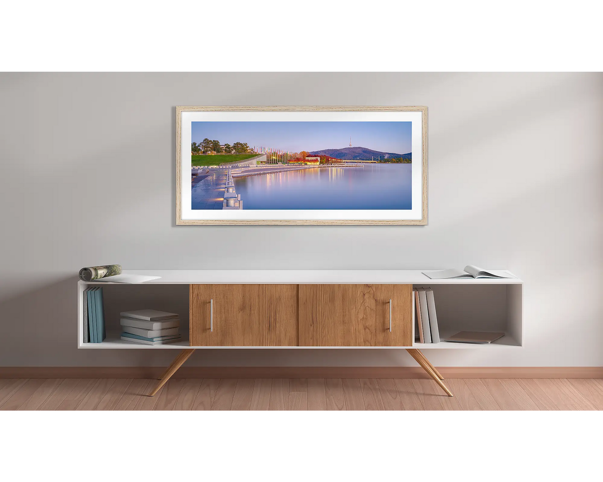 Before the Rush. Canberra sunrise wall art print with a Tasmanian Oak frame above a couch. 