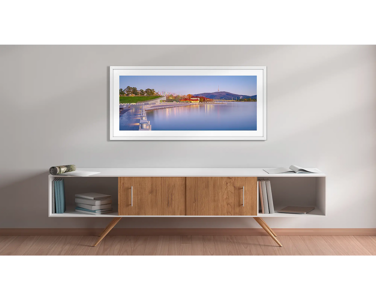 Before the Rush. Canberra sunrise wall art print with a white frame above a couch. 