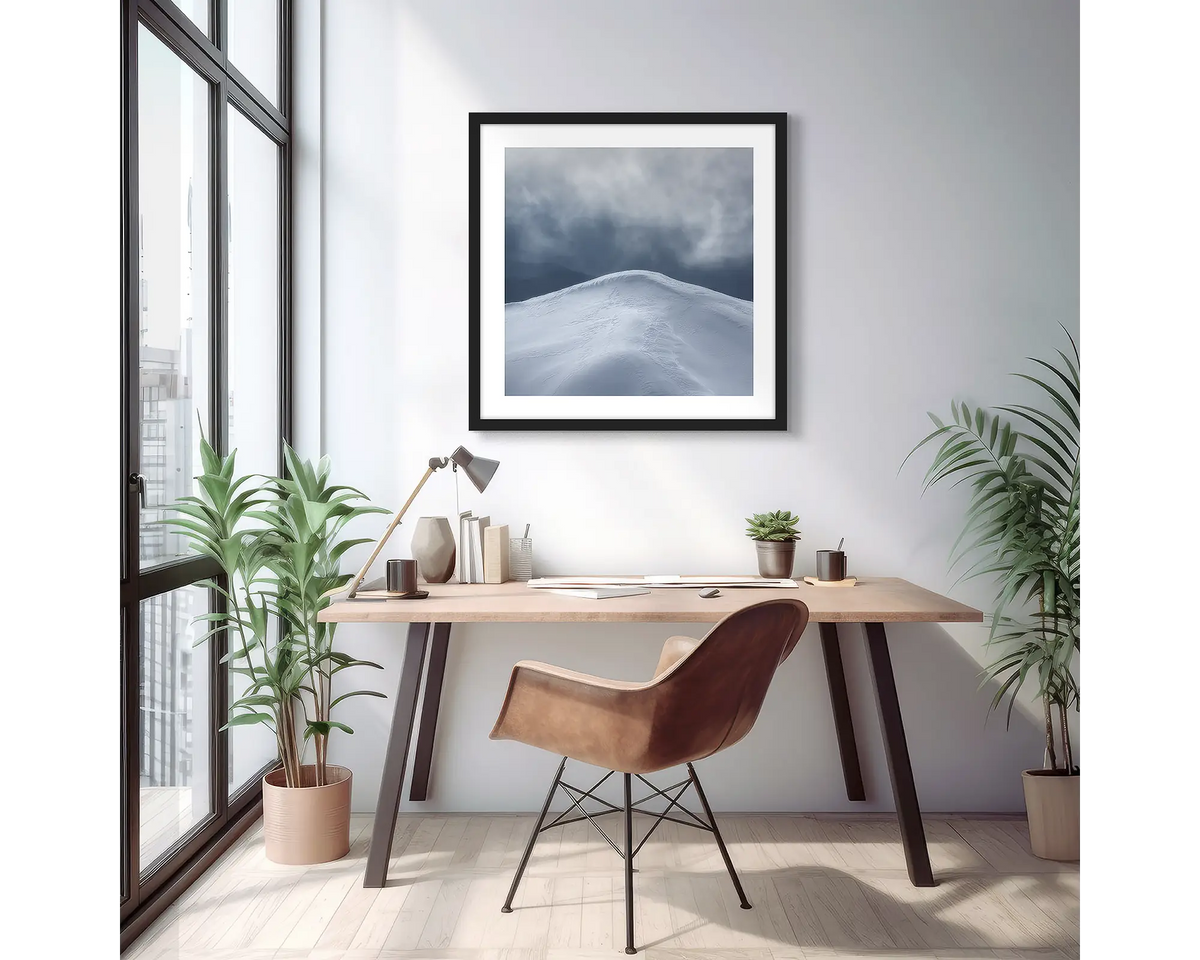 Beyond. Wall art print of a mountain peak with snow, with a black frame in a light filled apartment. 