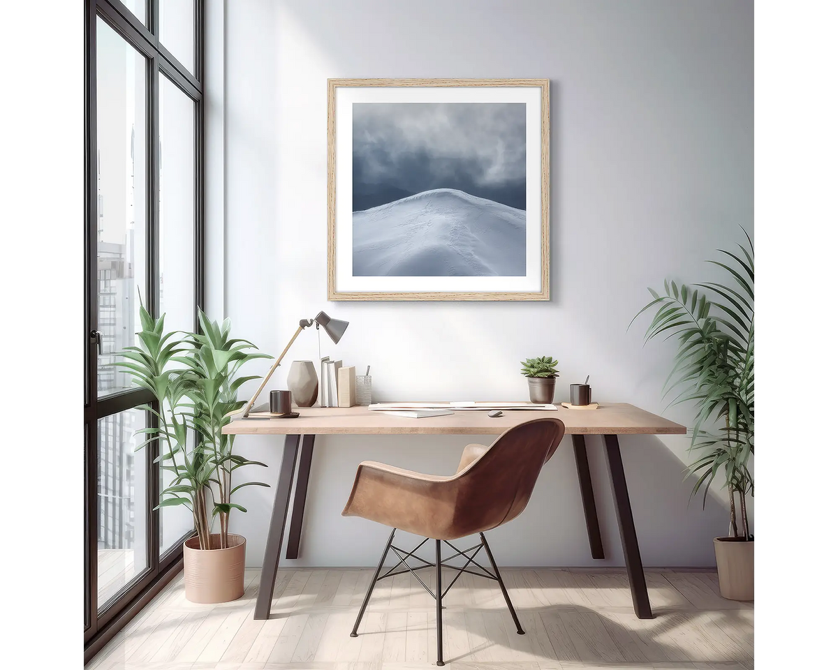 Beyond. Wall art print of a mountain peak with snow, with a timber frame in a light filled apartment. 