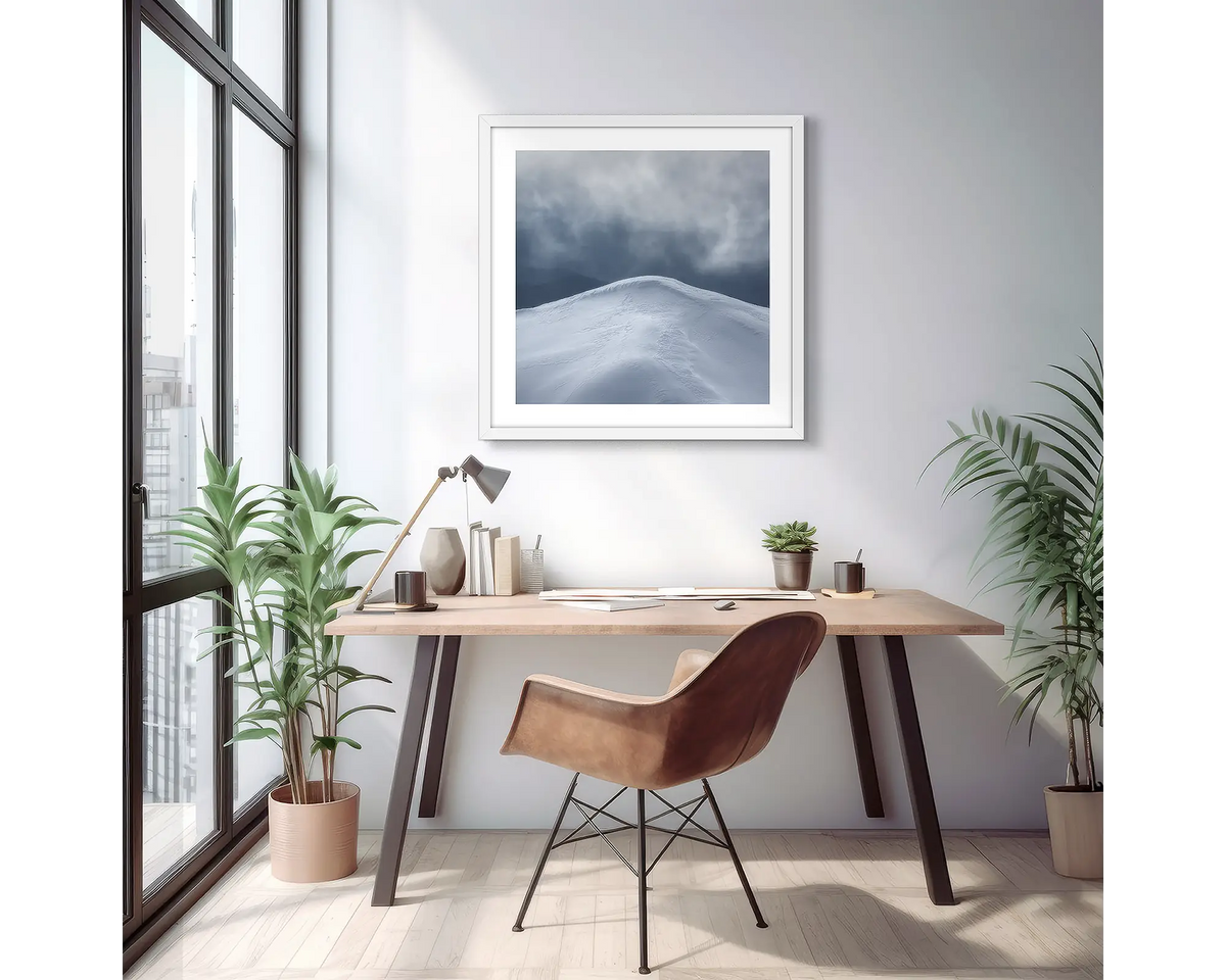 Beyond. Wall art print of a mountain peak with snow, with a white frame in a light filled apartment. 