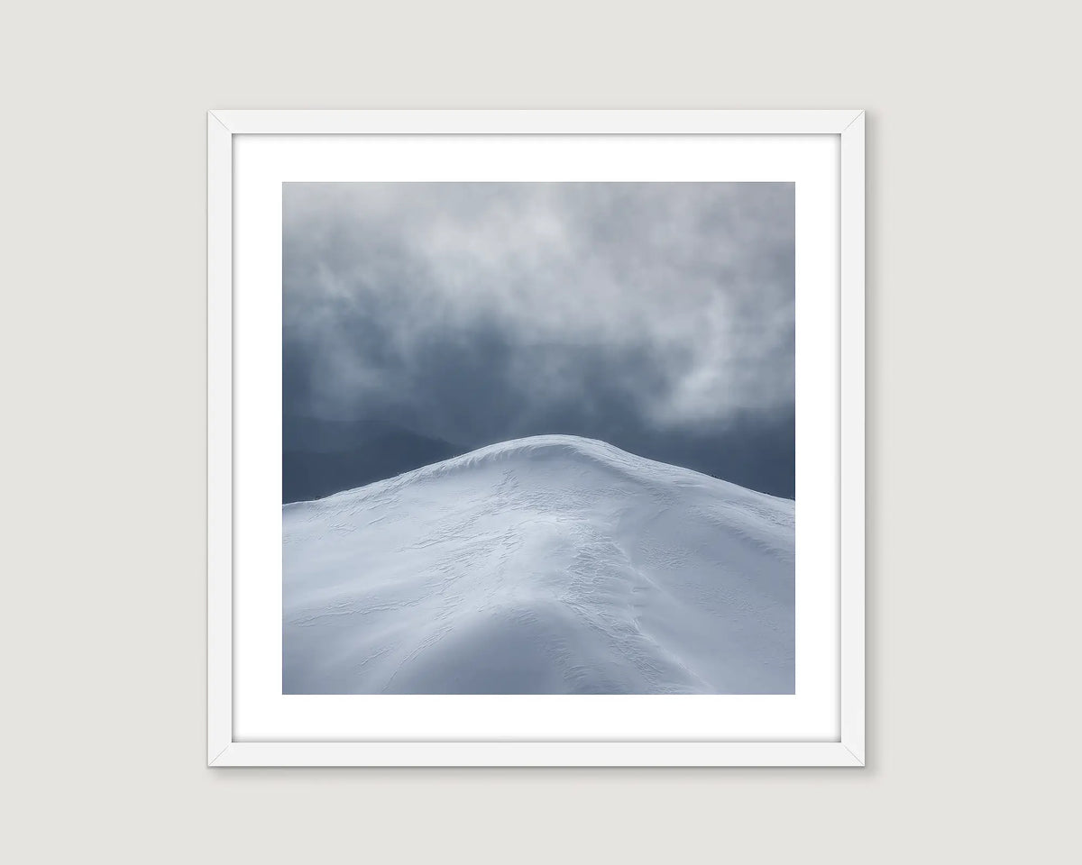 Framed photographic print of storm clouds over a snowy mountain peak in the Alpine National Park