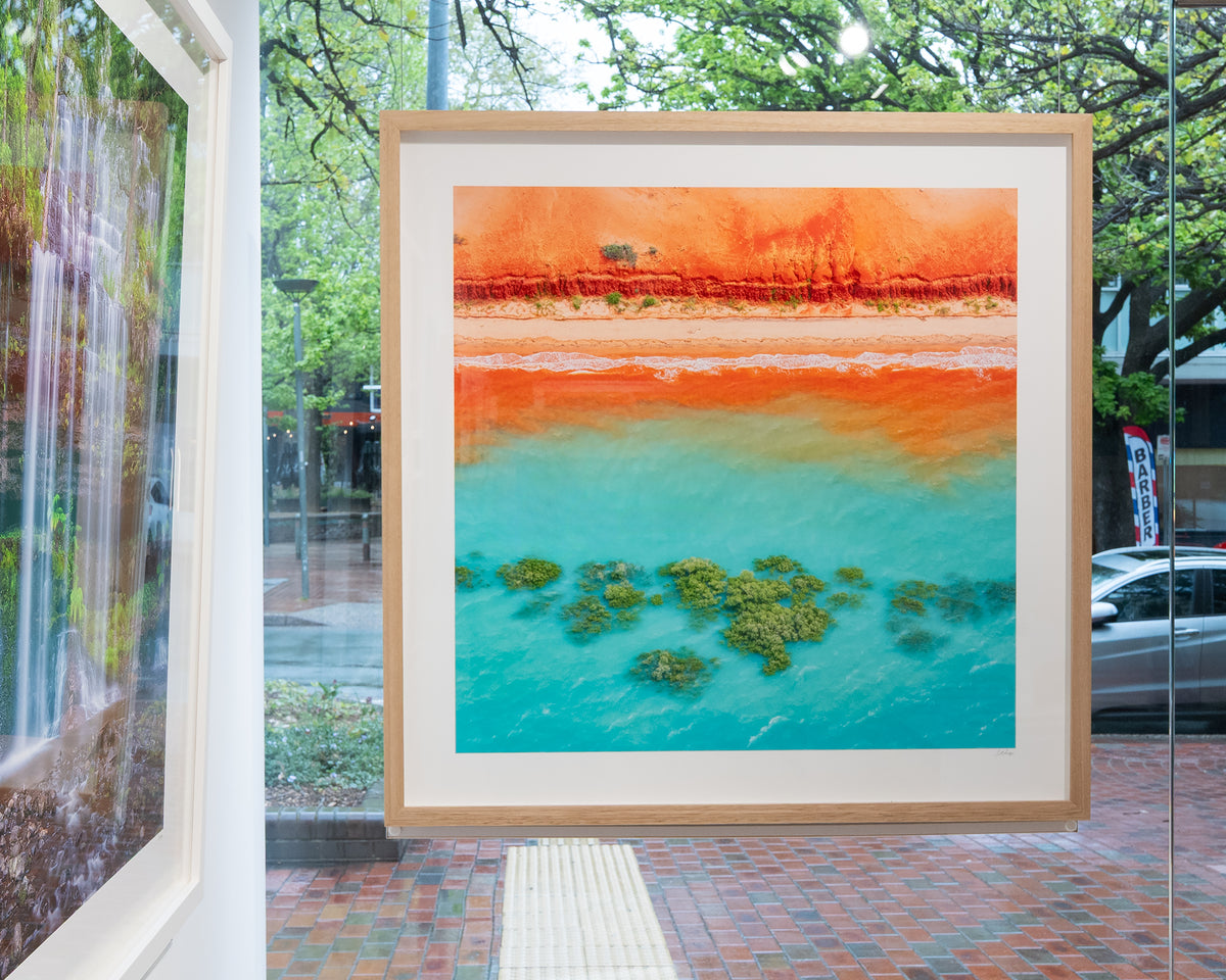 Blend. Abstract aerial artwork The Kimberley, Western Australia, with timber frame, in gallery window.