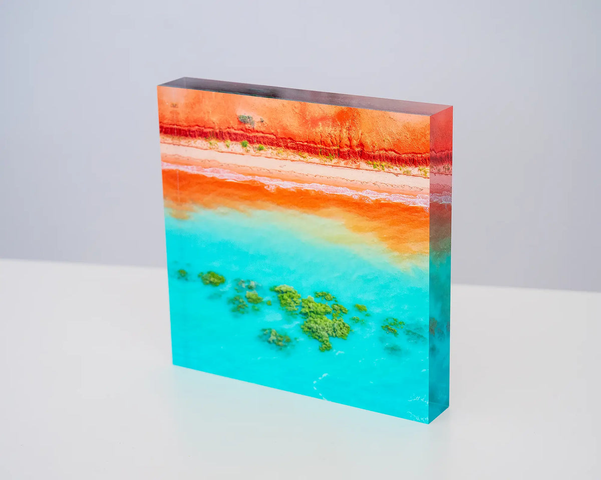 Blend. Acrylic block aerial coastal view of Broome, Western Australia, sitting on a desk.