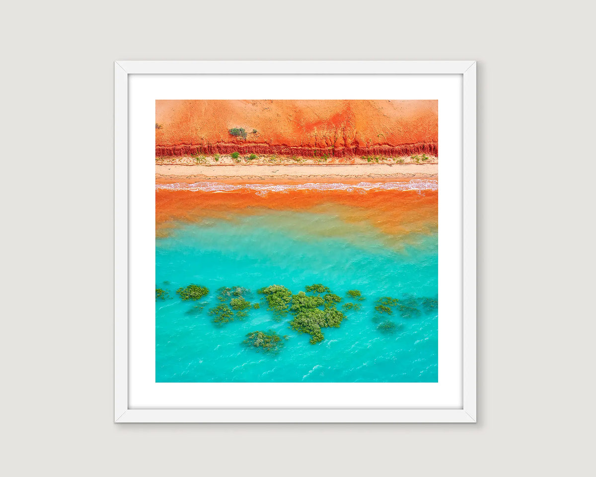 Framed photographic wall art print of an aerial view of red earth meeting the ocean near Broome. 