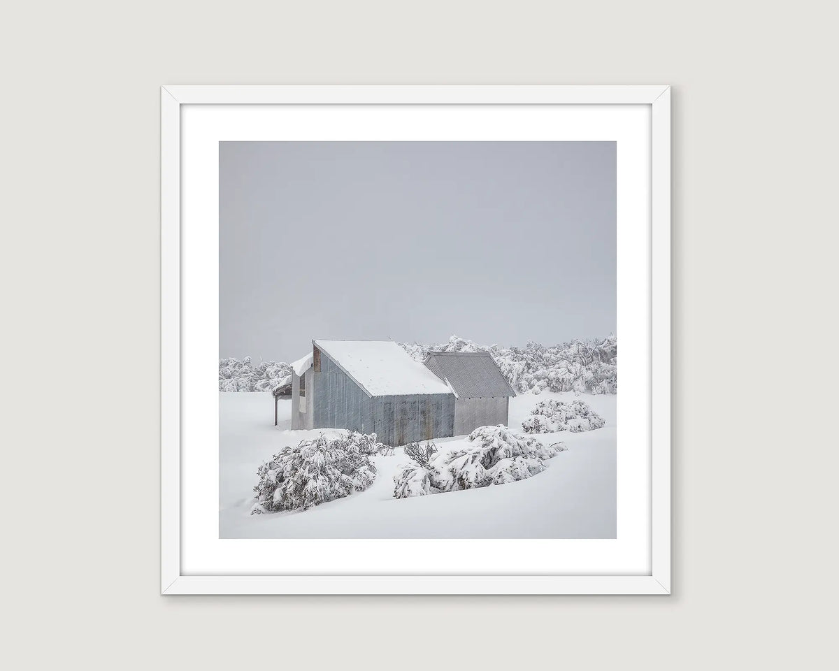 Framed wall art print of Blowhard Hut and snow gums in heavy snow fall on Mount Hotham. 