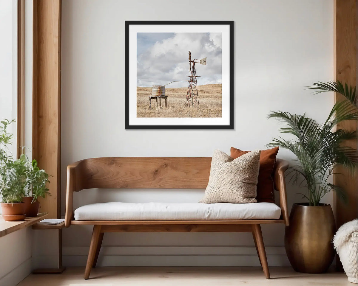 Blowing in the Wind. Black framed, rural wall art print hung in a scandi-themed waiting area. 