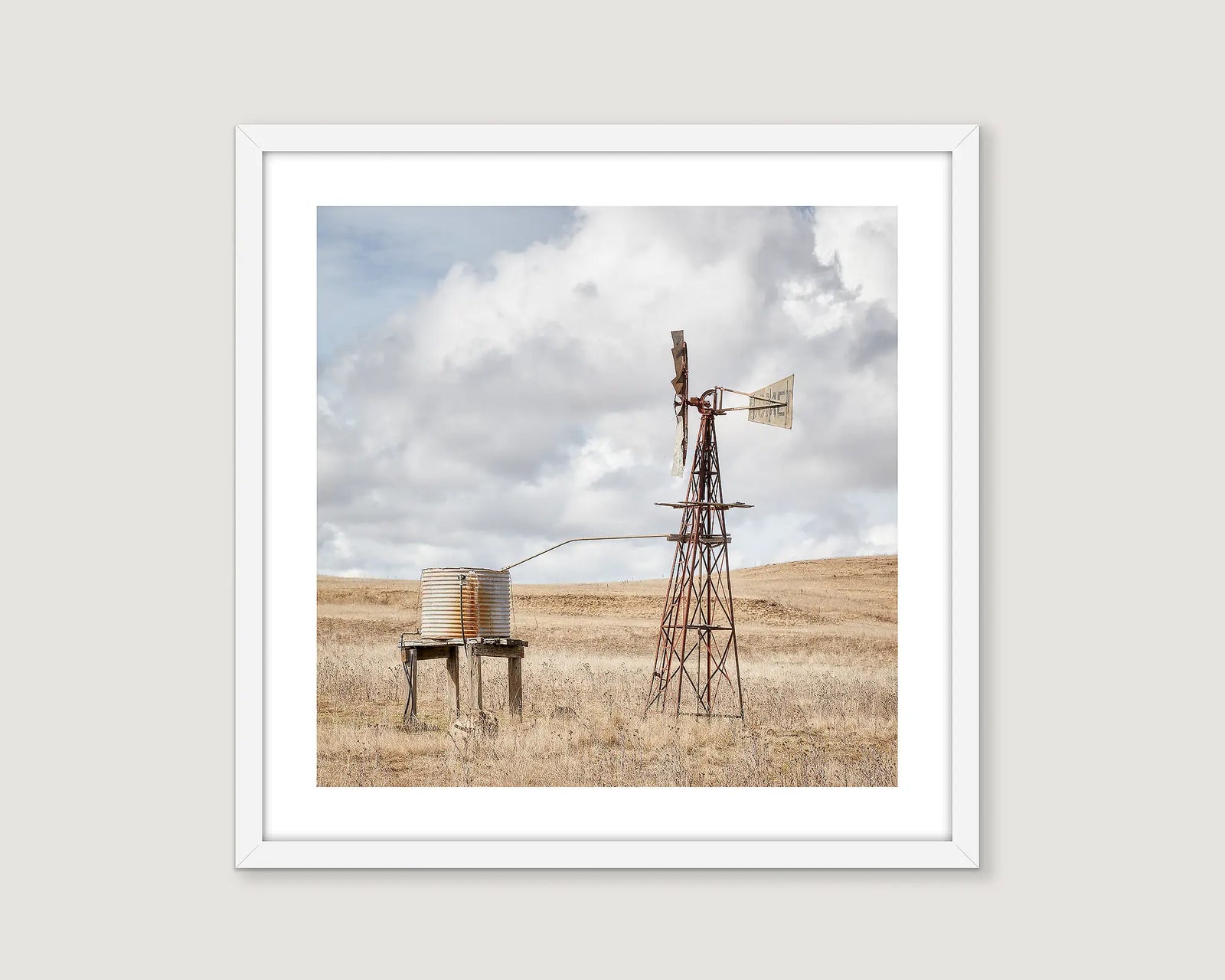Framed photograph of a windmill and water tank in a paddock at Rock Flat. 