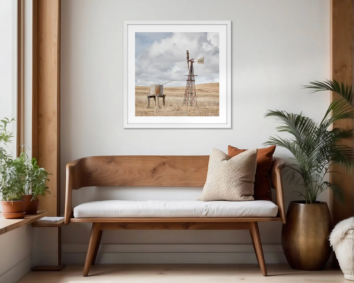 Blowing in the Wind. White framed, rural wall art print hung in a scandi-themed waiting area. 