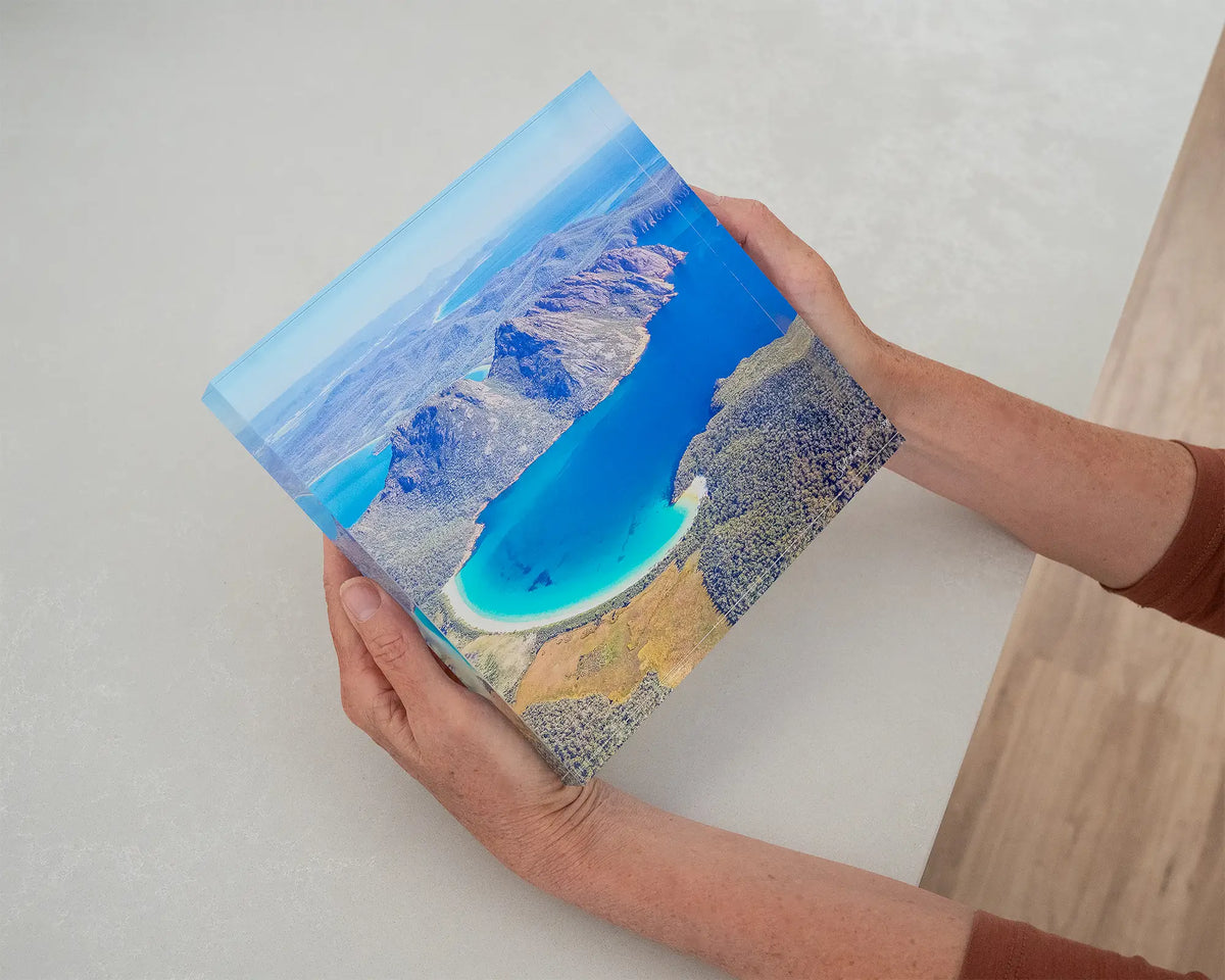 Blue Beauty. Acrylic block aerial view of Wineglass Bay Tasmania, held in hands.
