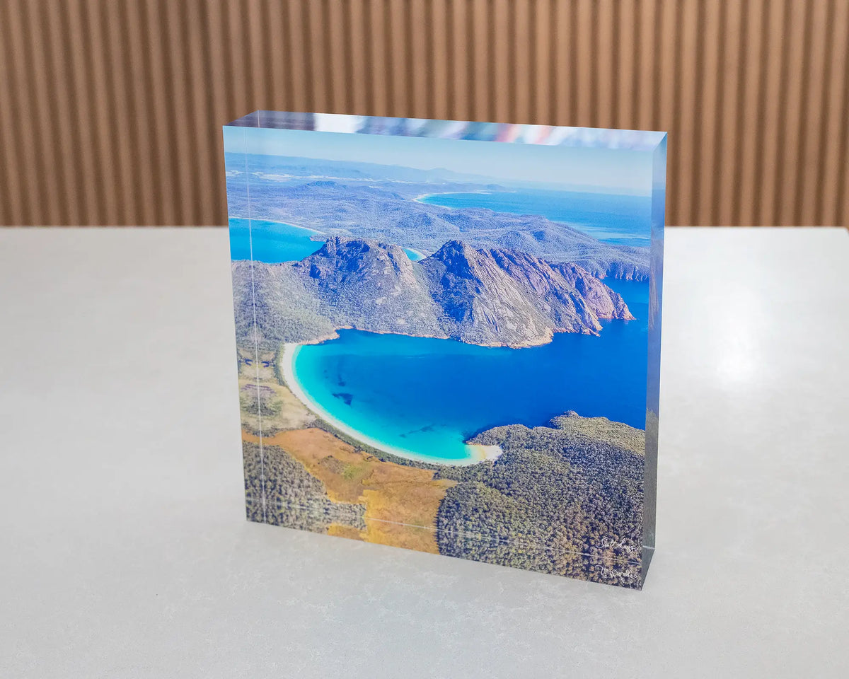 Blue Beauty. Acrylic block aerial view of Wineglass Bay Tasmania, on table in gallery.