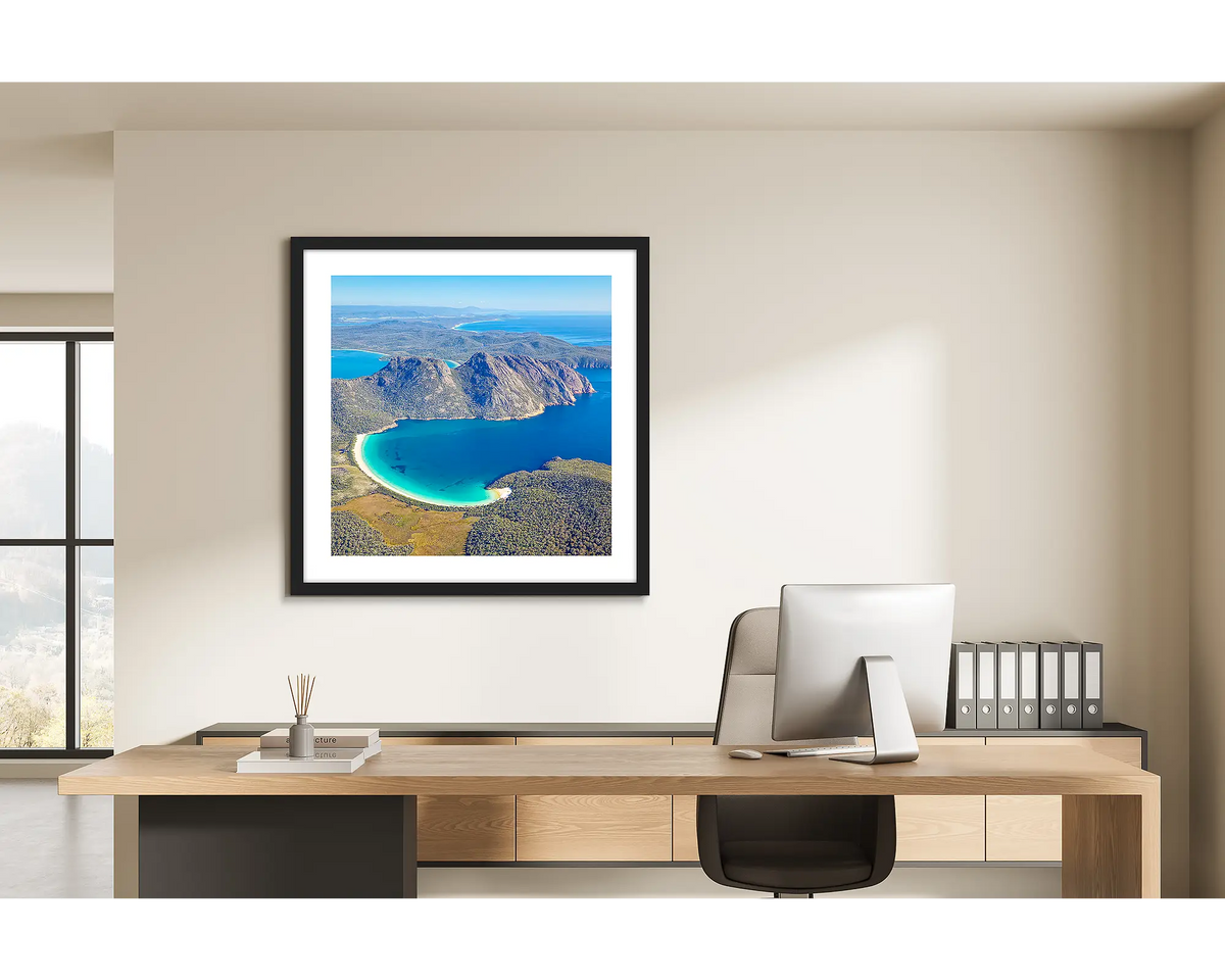 Blue Beauty. Wineglass Bay, Frecyinet National Park wall art print with a black frame hung behind a study desk. 