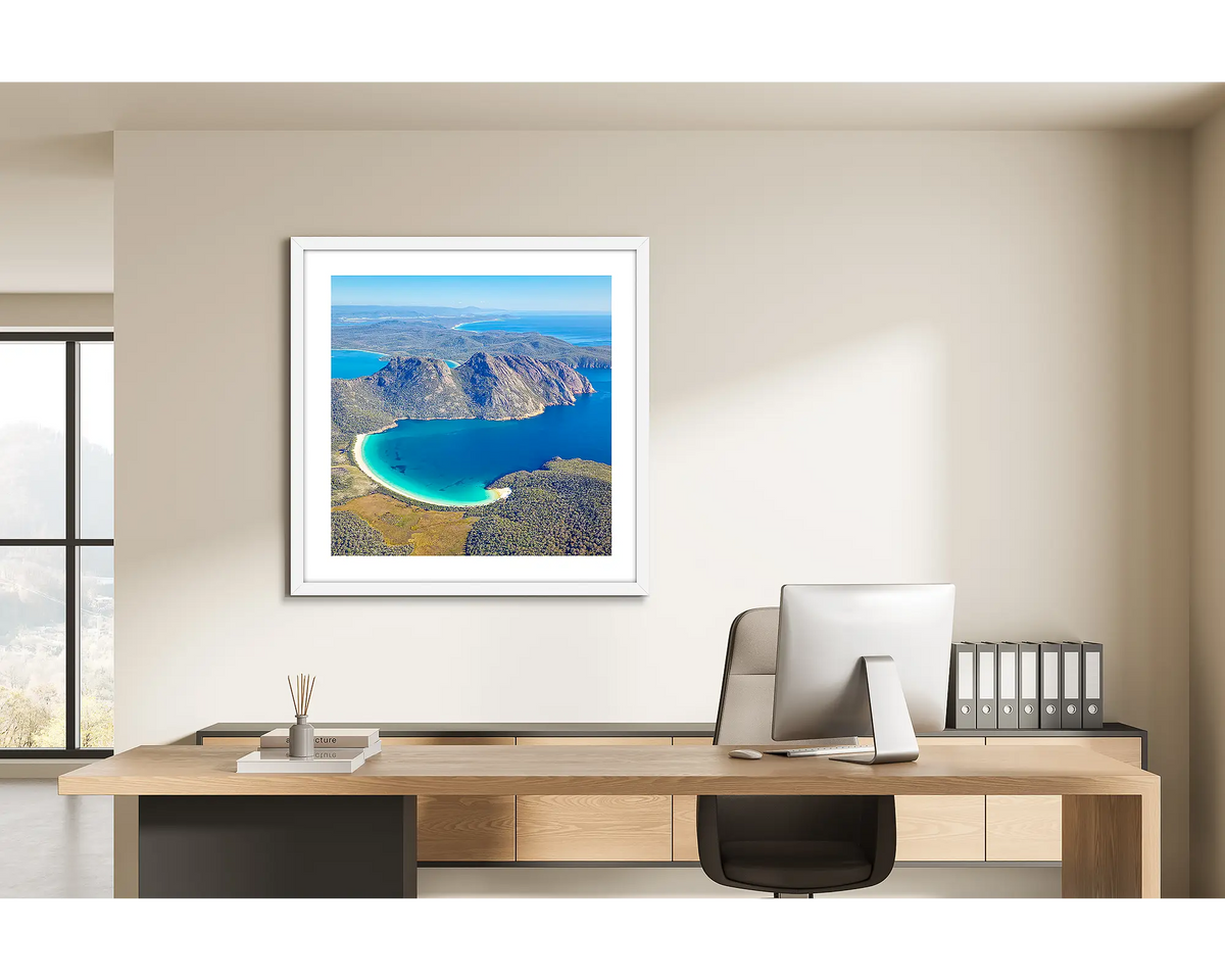Blue Beauty. Wineglass Bay, Frecyinet National Park wall art print with a white frame hung behind a study desk. 