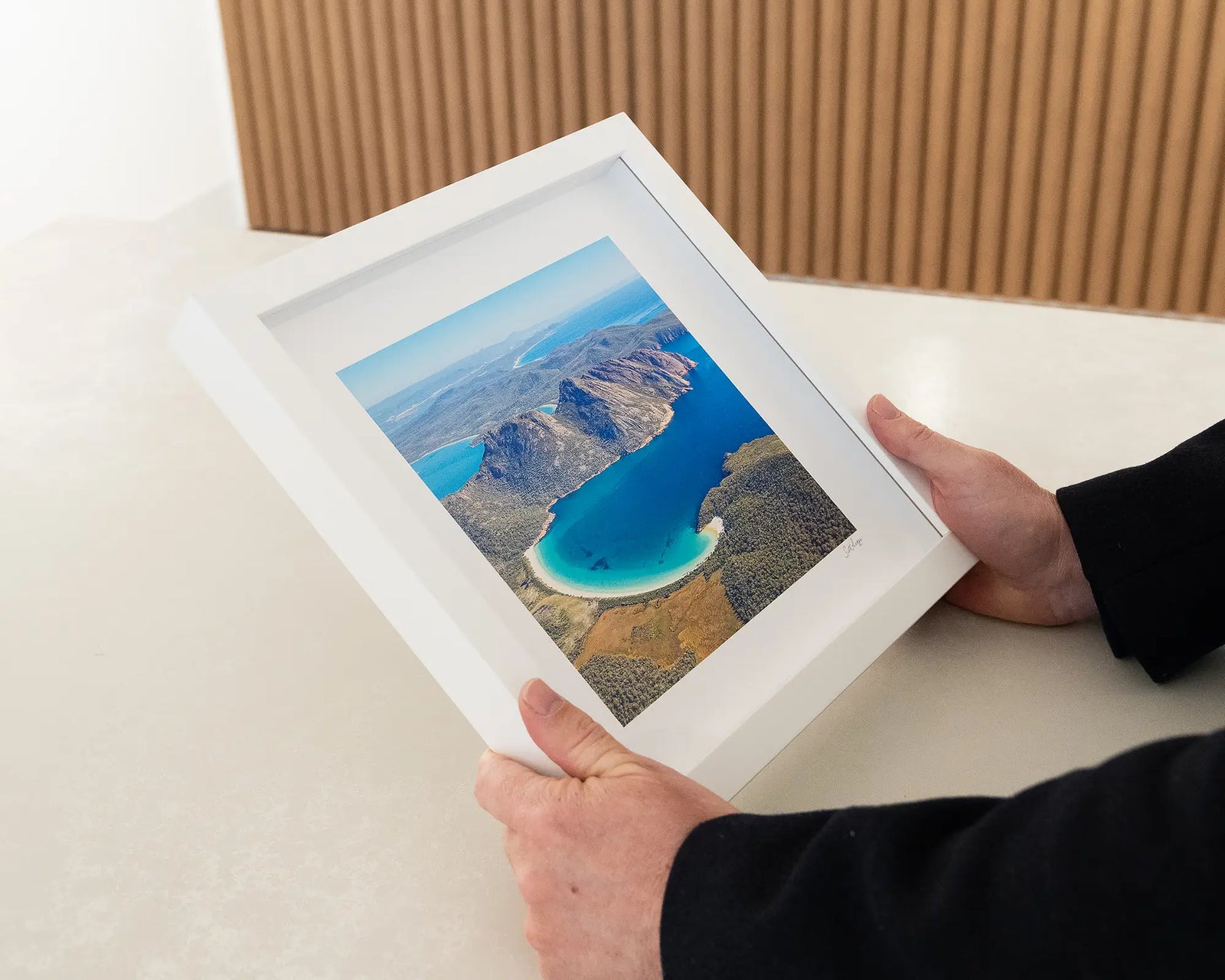 Framed photograph of Wineglass Bay, Freycinet National Park, from an aerial view. 