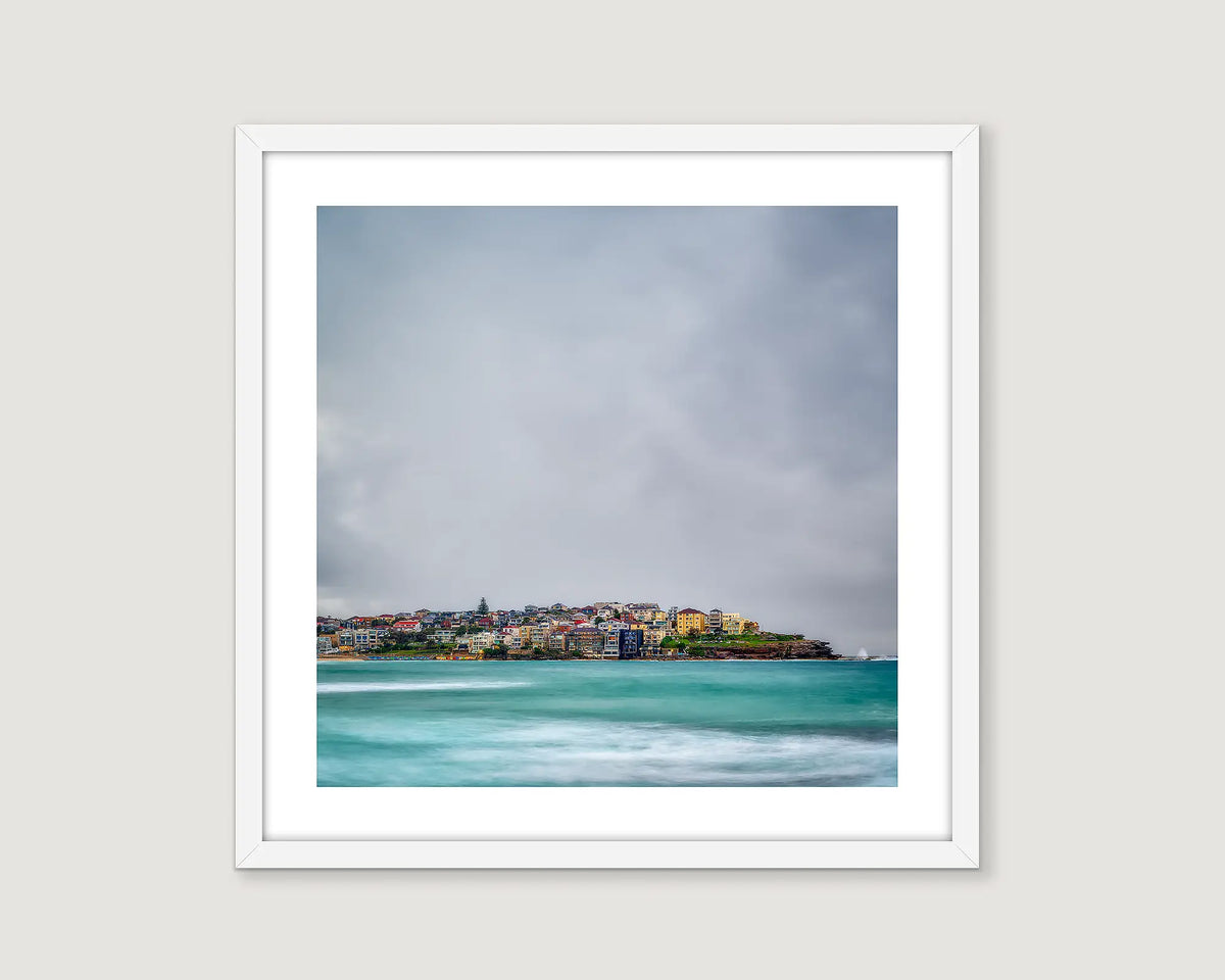 Framed artwork of a coastal scene of Bondi with a stormy sunrise. 
