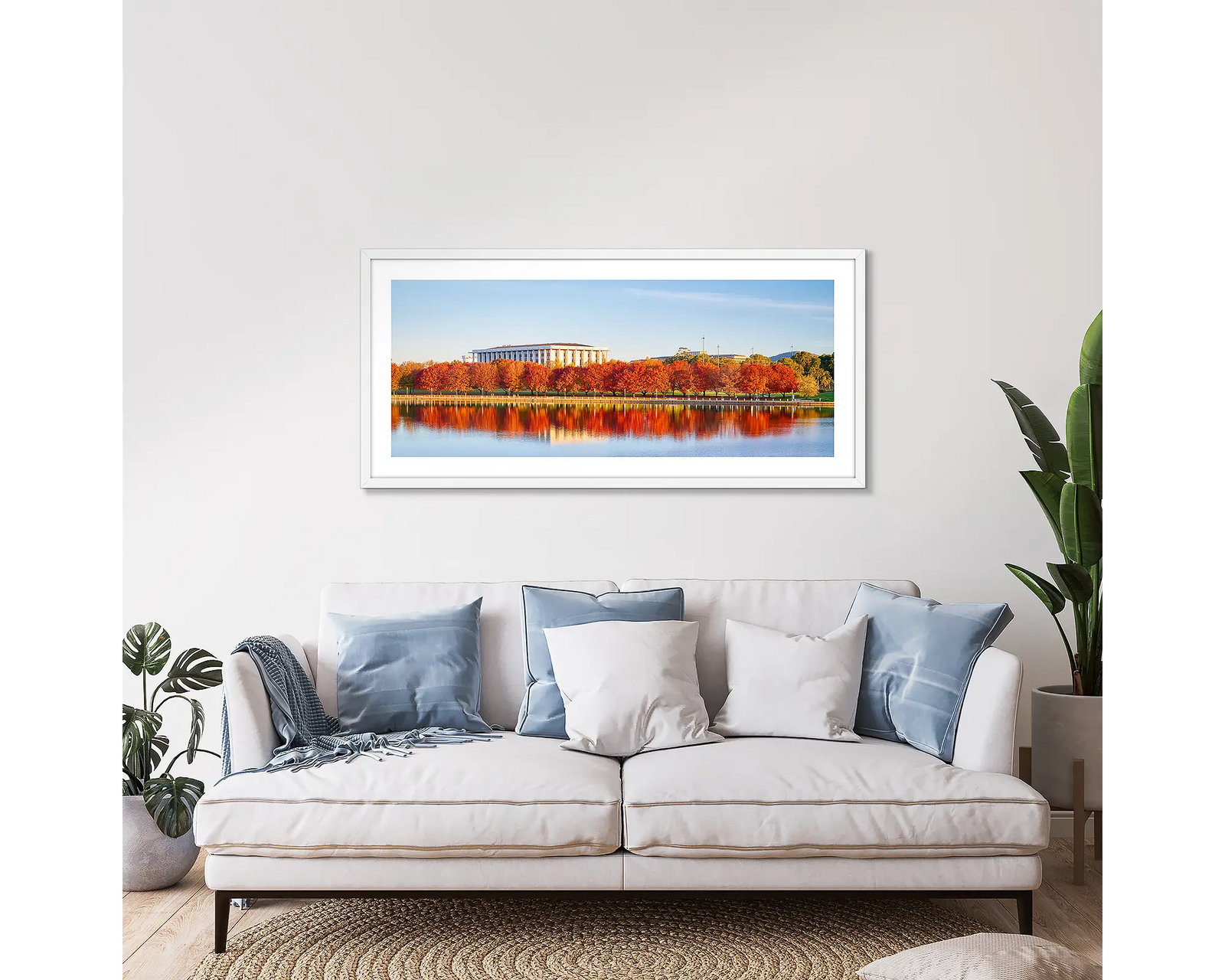 Bookend. Red trees reflecting in Lake Burley Griffin beside the National Library of Australia.