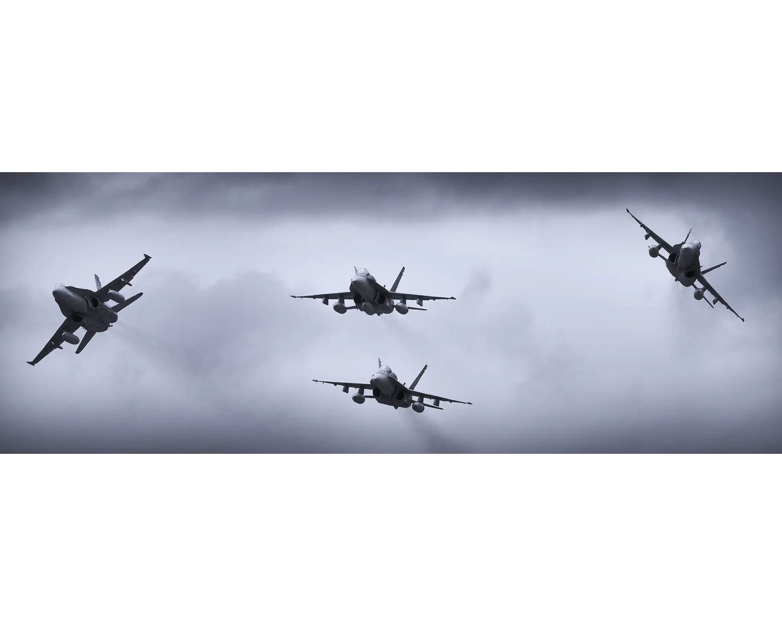 Royal Australian Air Force F/A-18 Hornets breaking formation.