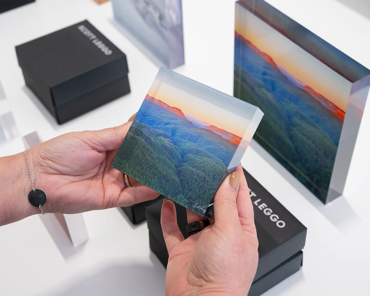 Breaking Dawn. Acrylic block of sunrise over the Blue Mountains, being hand held.