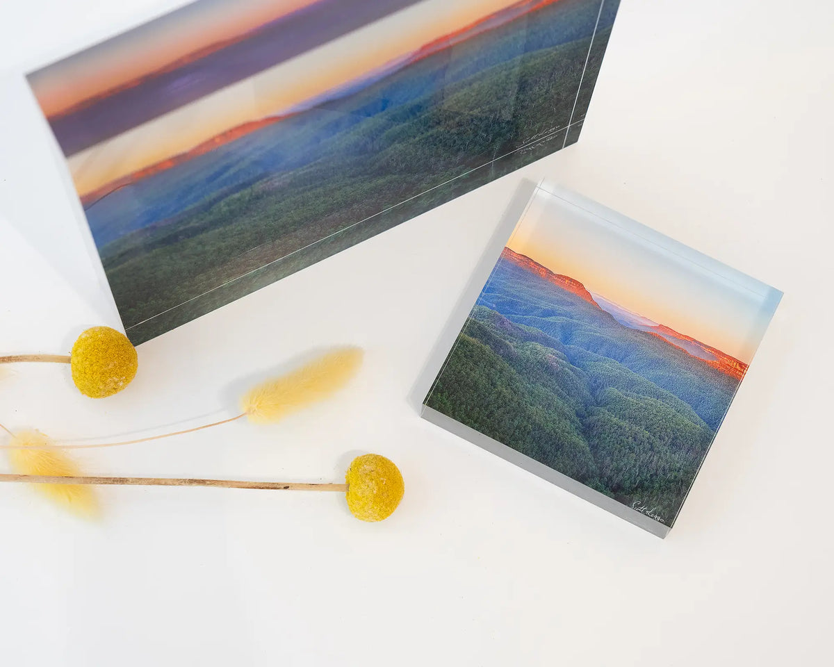 Breaking Dawn. Acrylic block sunrise over Blue Mountains National Park, laying flat on desk with 19cm block upright.