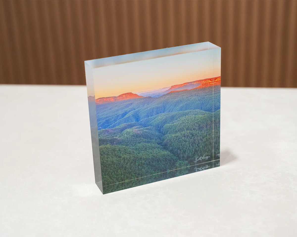 Breaking Dawn. Acrylic block of sunrise over Blue Mountains National Park, sitting on a desk.