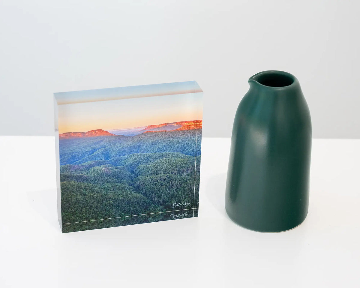 Breaking Dawn. Acrylic block sunrise over Blue Mountains National Park, styled with small vase.