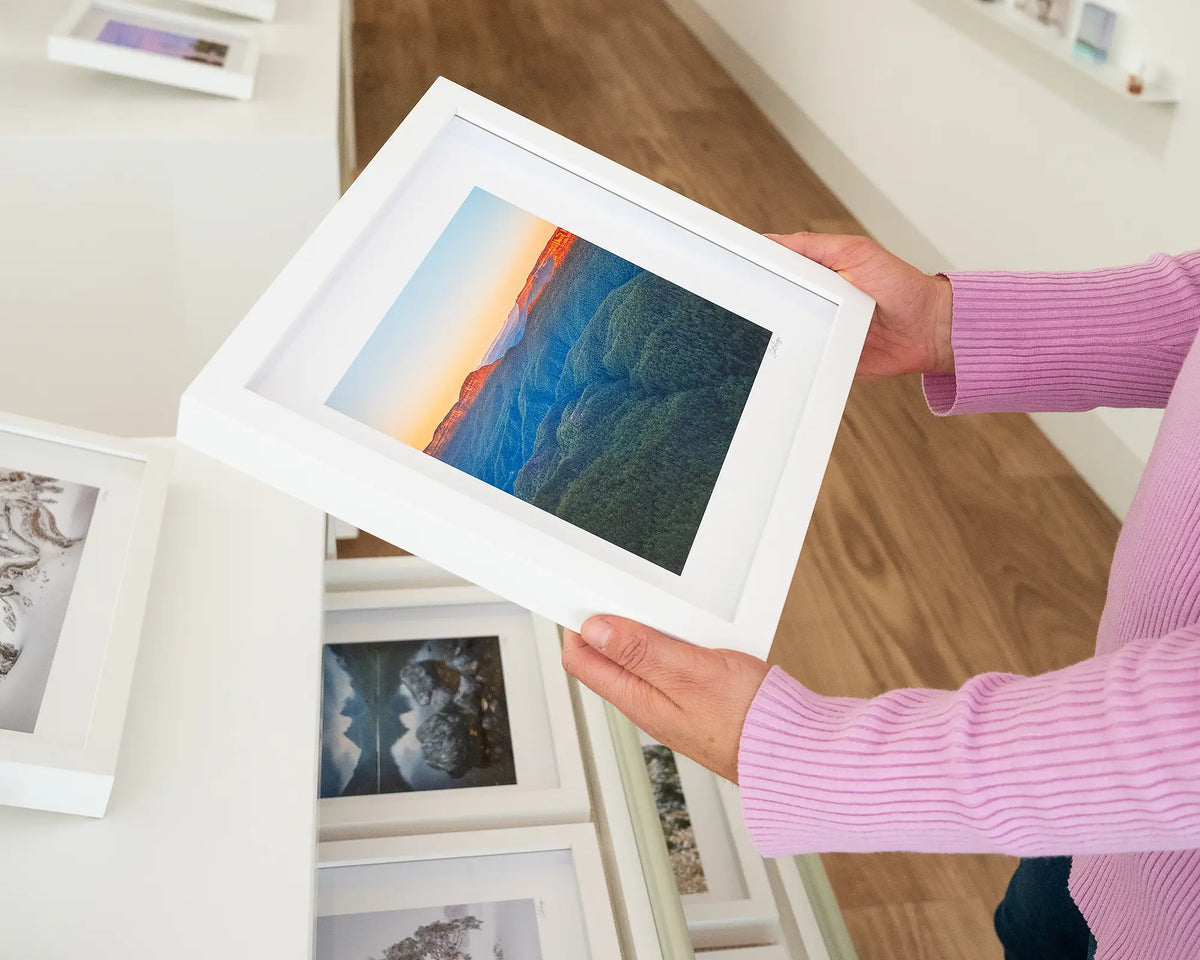 Breaking Dawn. Sunrise over Blue Mountains National Park, small print with white frame, hand held in gallery.