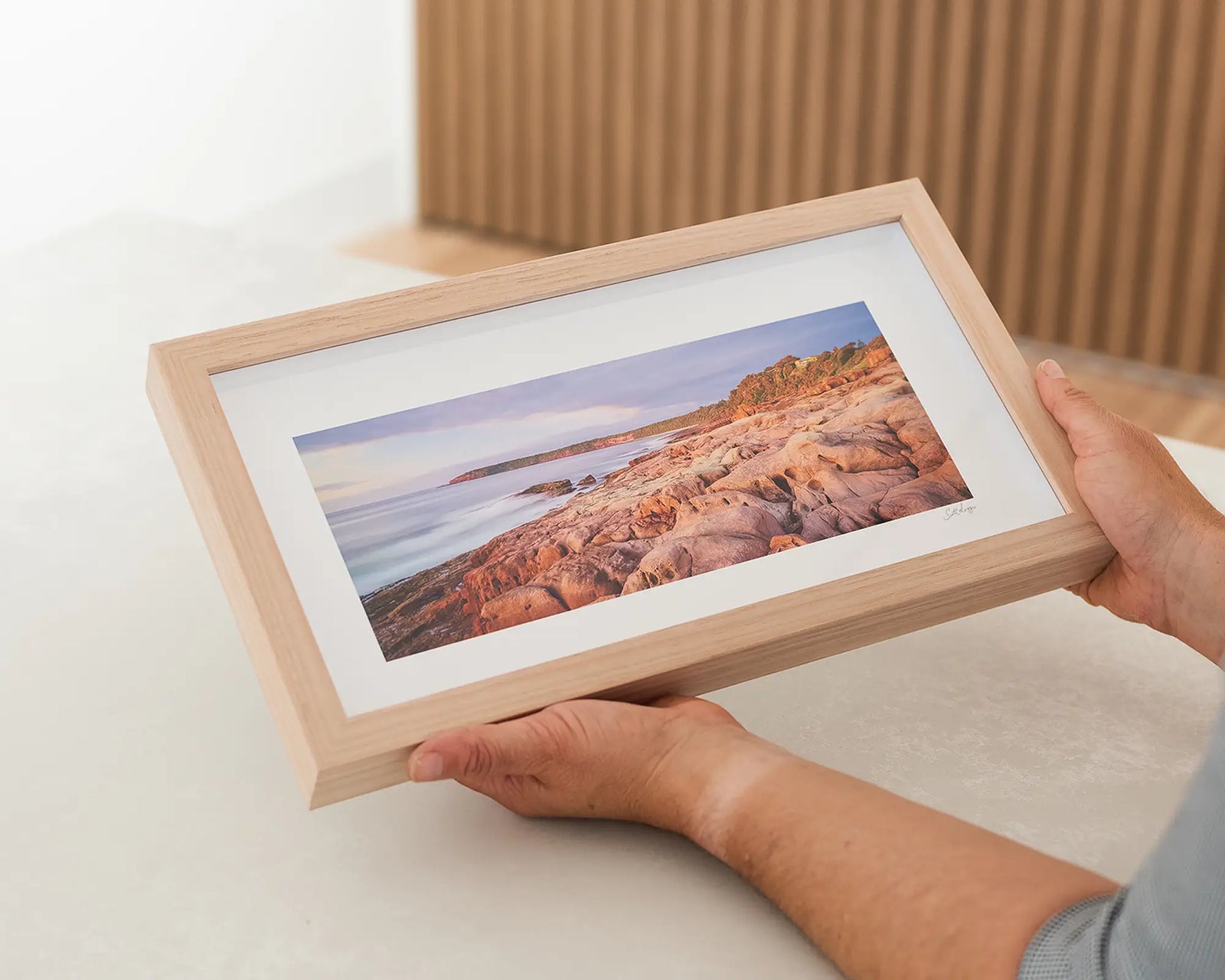 Framed wall art print of a coastal scene of a sunrise over rugged rocks at Short Point, Merimbula. 
