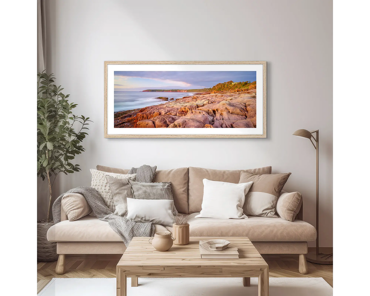 Breaking Through. South Coast photographic wall art print with a Tassie Oak frame, hung in a scandi lounge room. 
