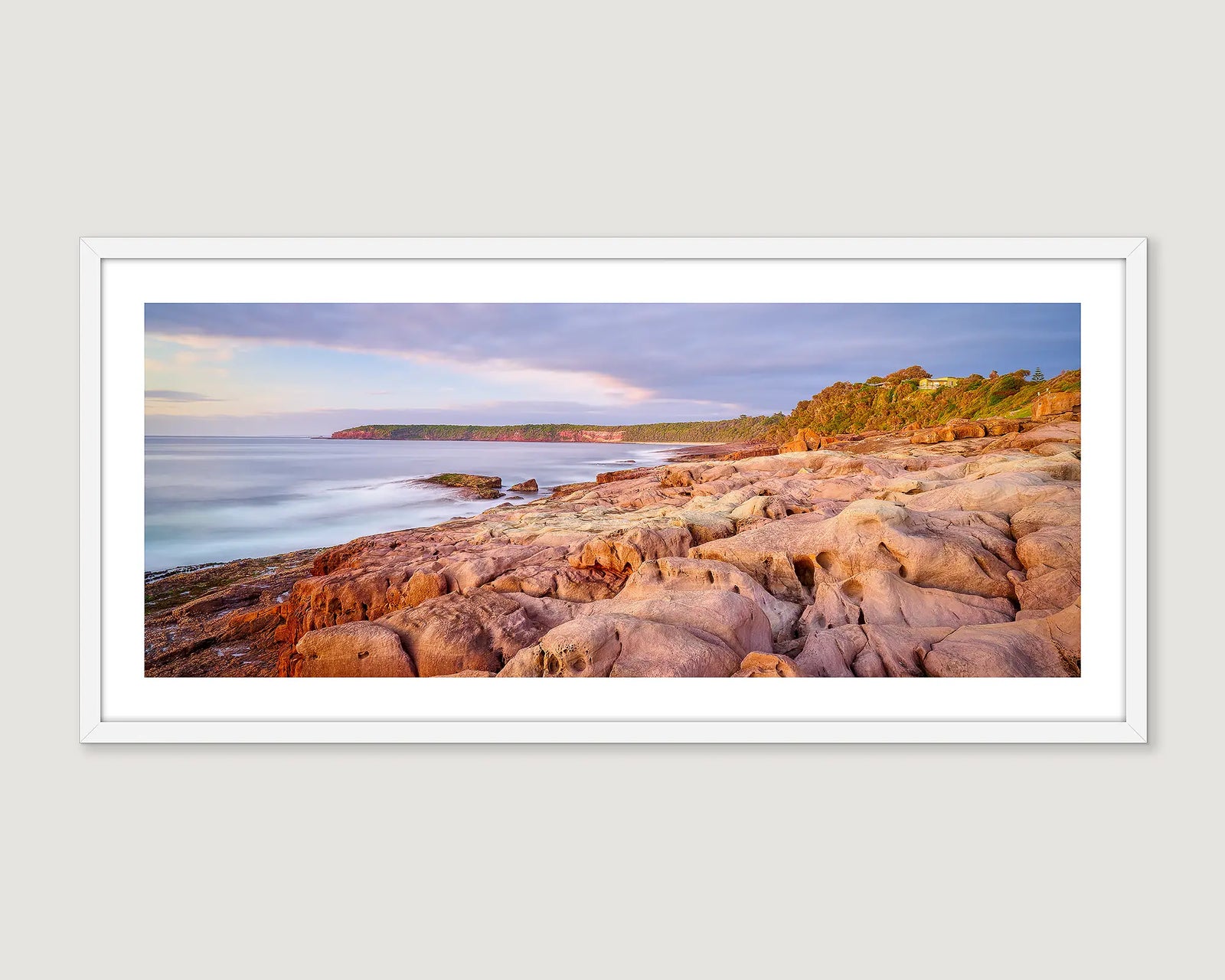 Framed wall art print of a coastal scene of a sunrise over rugged rocks at Short Point, Merimbula. 