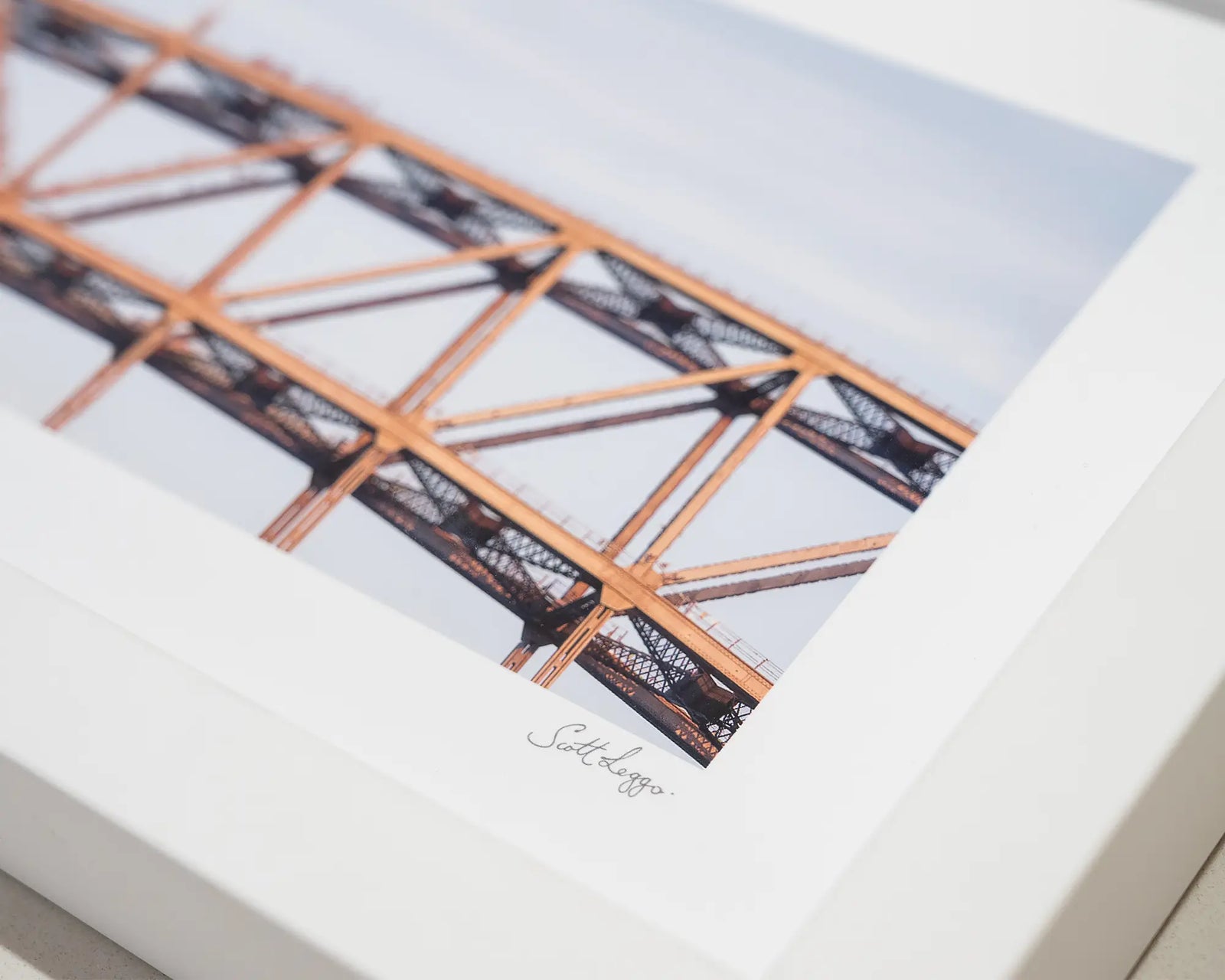 Framed photograph of climbers on top of Sydney Harbour Bridge. 