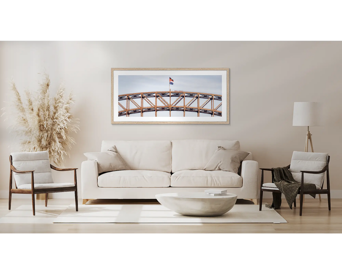 Bridge Climb. Sydney Harbour Bridge wall art with a Tassie Oak frame, above a couch. 