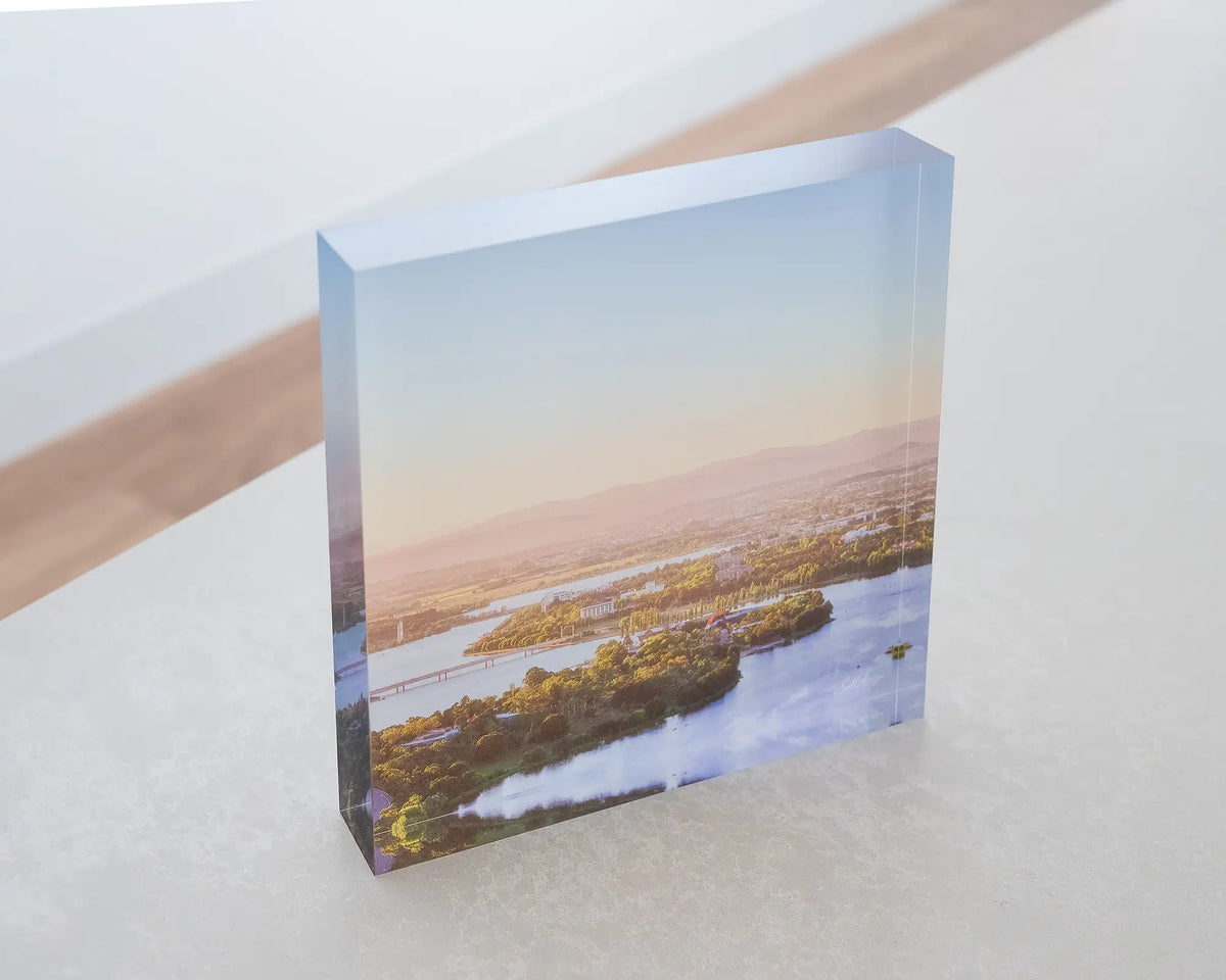 Brighter Days. Acrylic block of an Autumn morning over Lake Burley Griffin Canberra, sitting on a desk.