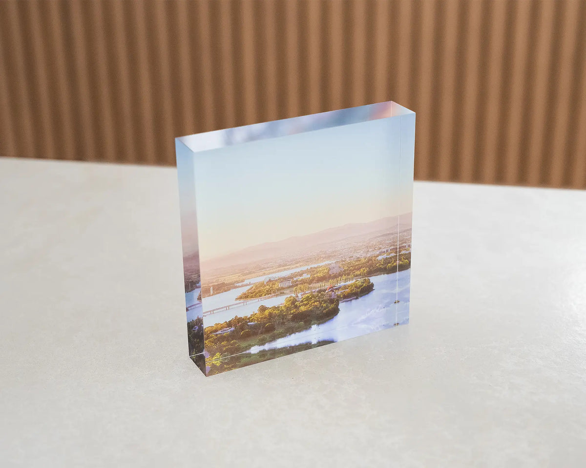 Brighter Days. Acrylic block of Autumn sunrise over Lake Burley Griffin Canberra, sitting on a table.