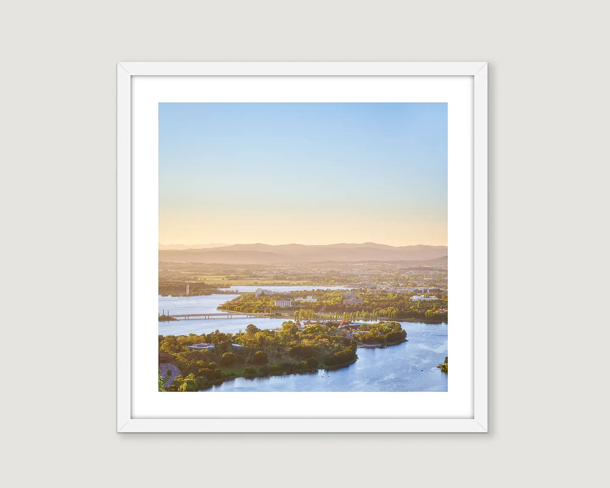 Framed photograph from an aerial perspective of Lake Burley Griffin and Canberra surrounds with a view to the Brindabella Ranges. 