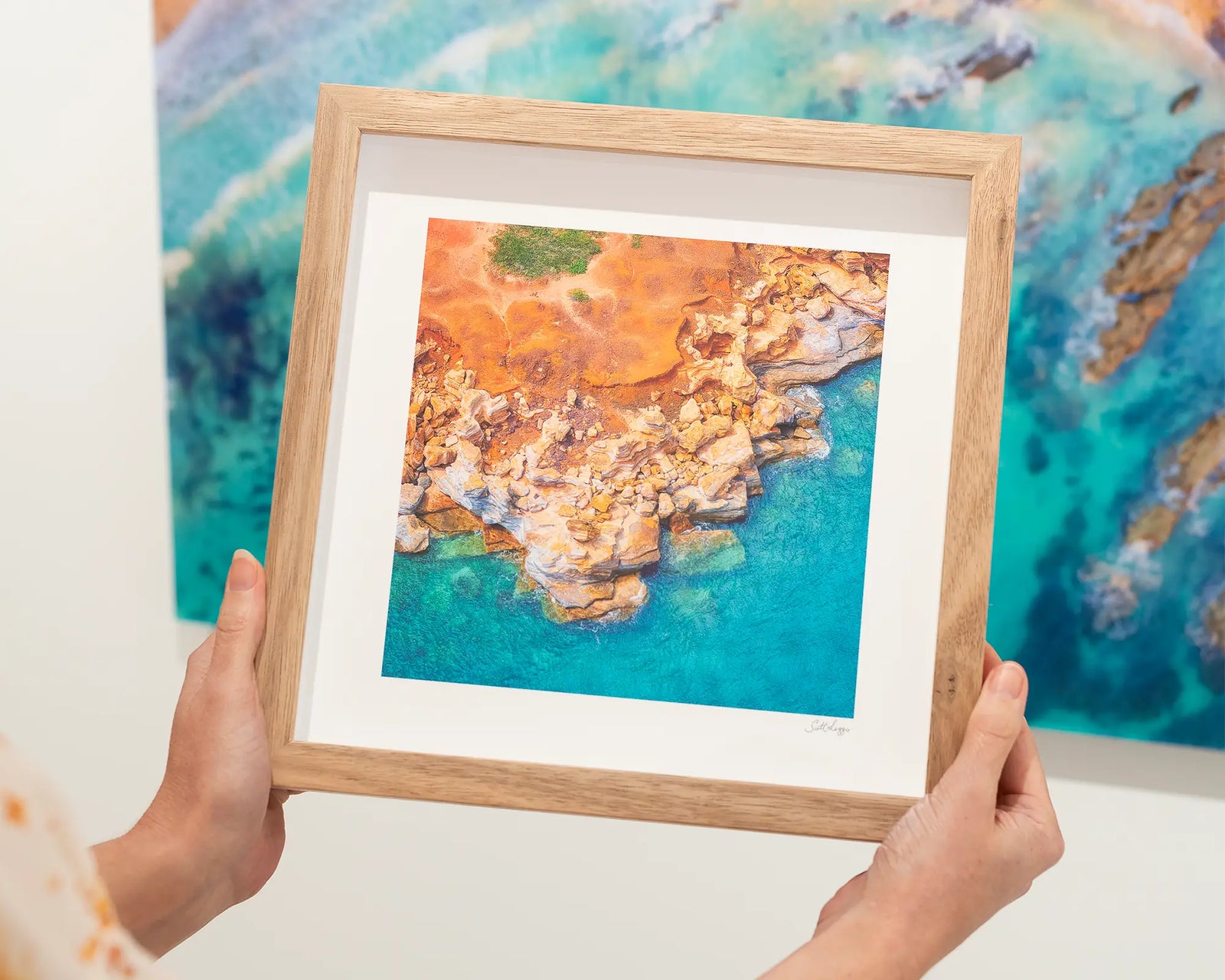 Framed Photographic aerial image of red rocks meeting the ocean at Gantheaume Point.