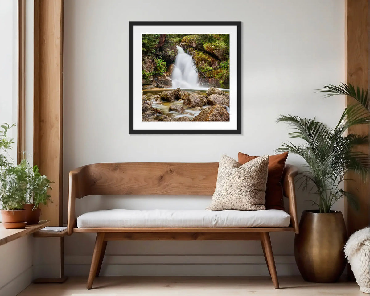 Buffalo Flow. Black framed wall art print of Ladies Bath Falls, hung in a scandi-themed waiting area. 