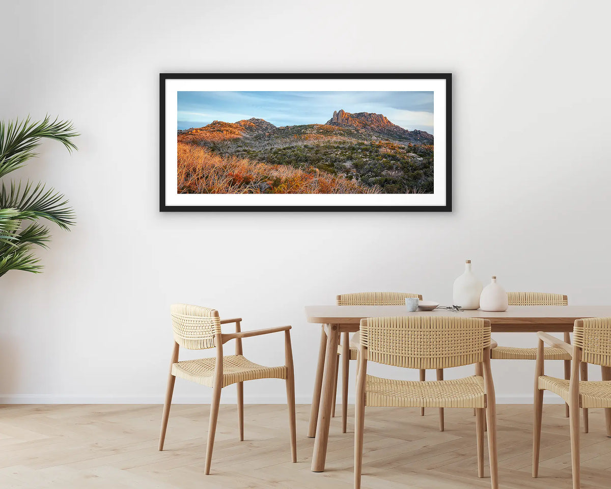 Buffalo Heights. Photographic wall art print of Mount Buffalo at sunset, with a black frame hung in a dining room. 