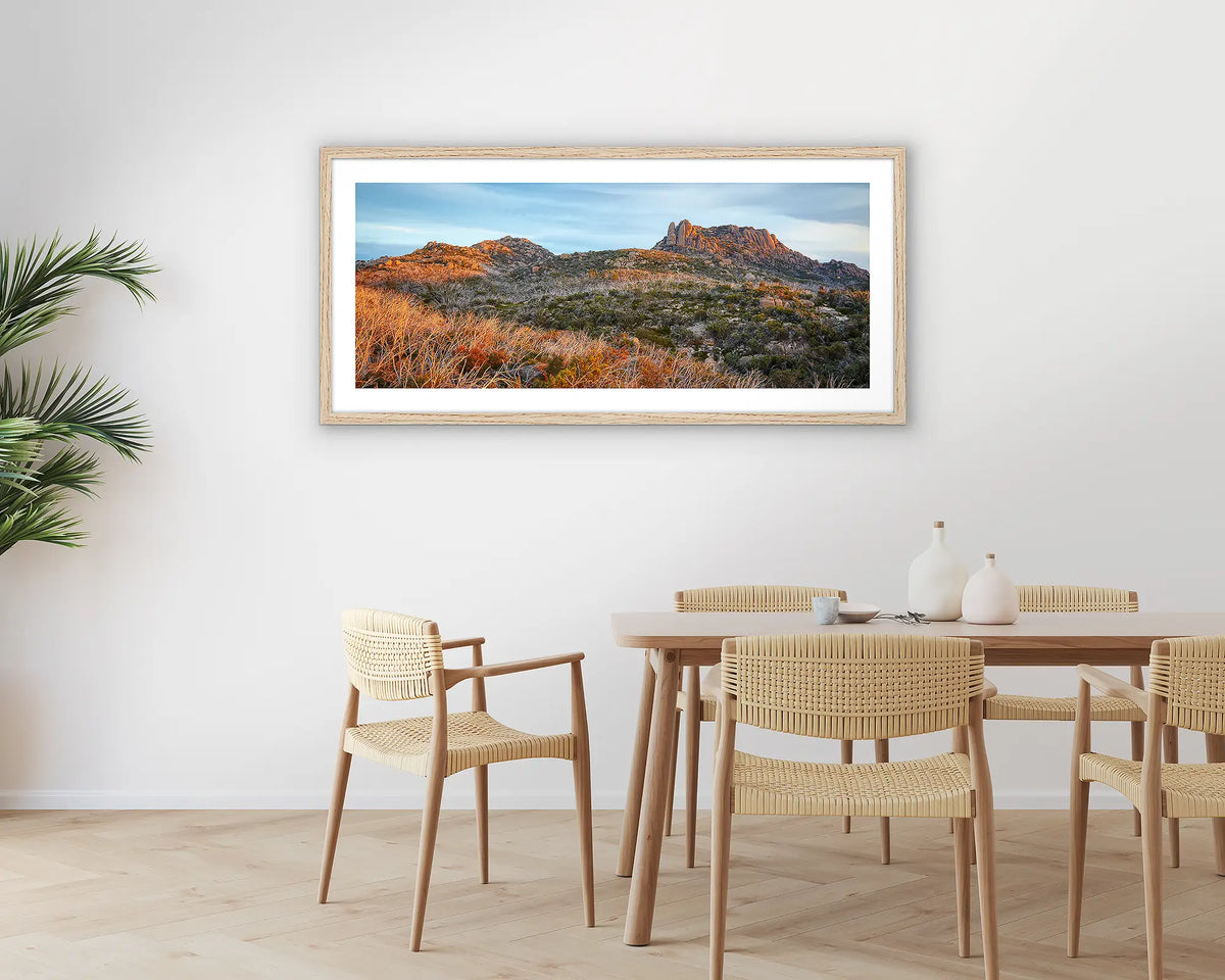 Buffalo Heights. Photographic wall art print of Mount Buffalo at sunset, with a timber frame hung in a dining room. 