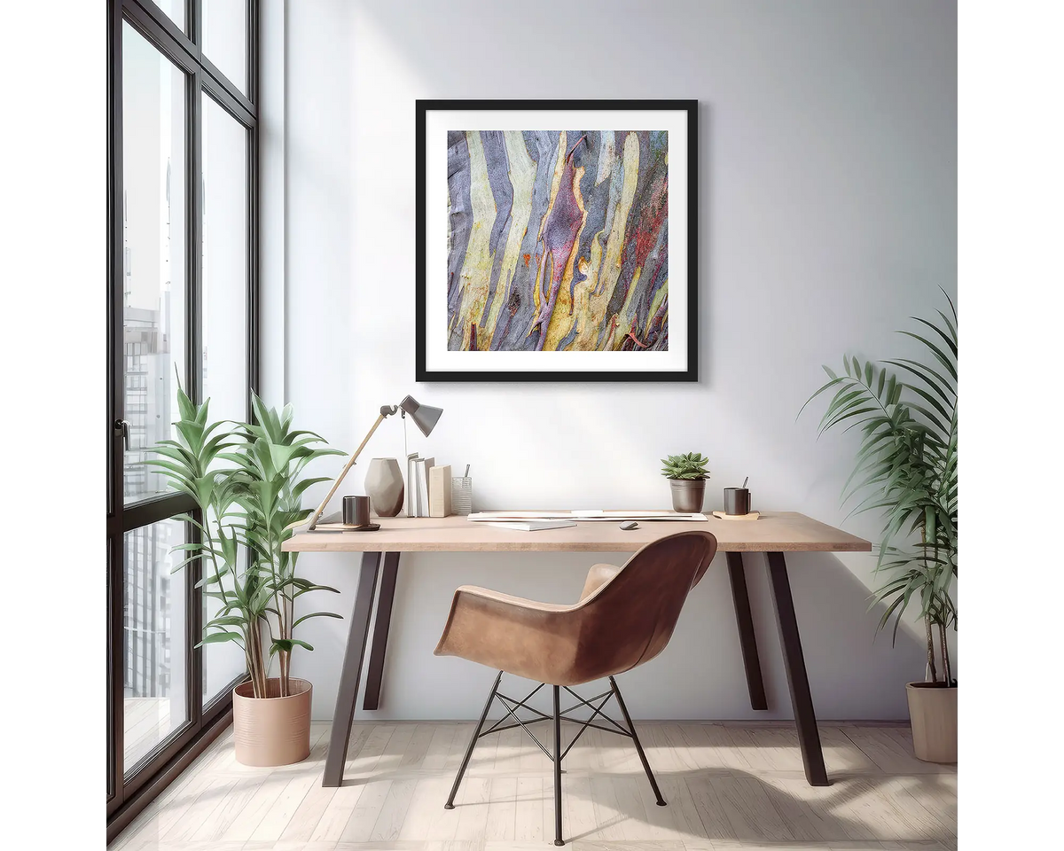 Buller Bark. Abstract snow gum wall art print with a black frame, hung on an apartment wall above a small desk. 