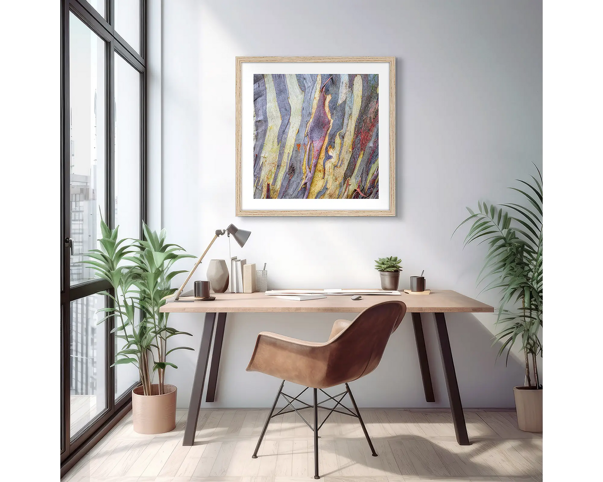 Buller Bark. Abstract snow gum wall art print with a timber frame, hung on an apartment wall above a small desk. 