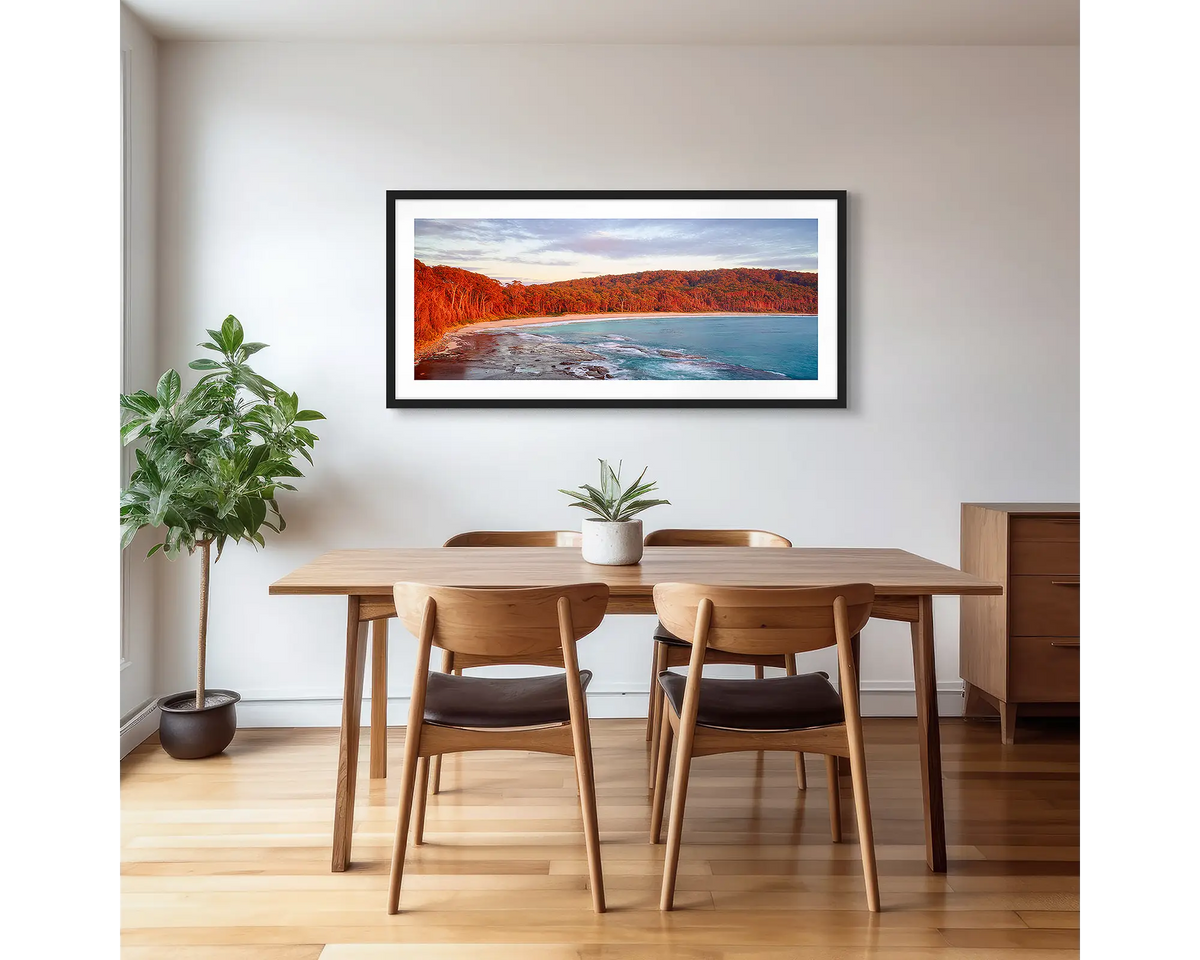 Calm at Depot Beach. Framed wall art print of a sunrise at Depot Beach, South Coast, with a black frame and hung on a dining area wall.