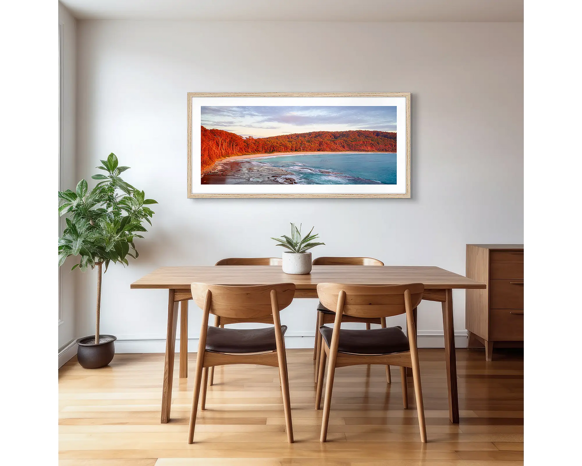 Calm at Depot Beach. Framed wall art print of a sunrise at Depot Beach, South Coast, with a timber frame and hung on a dining area wall.