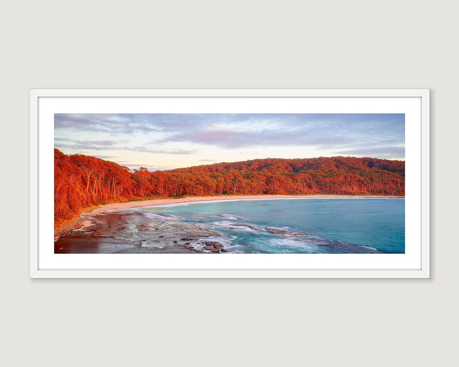 Framed photograph of a sunrise at Depot Beach with turquoise coastal waters. 