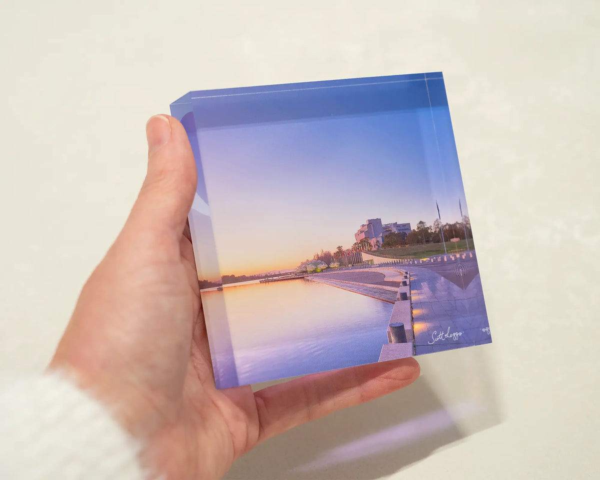 Canberra Awakes. Acrylic block of sunrise over Lake Burley Griffin, hand held.