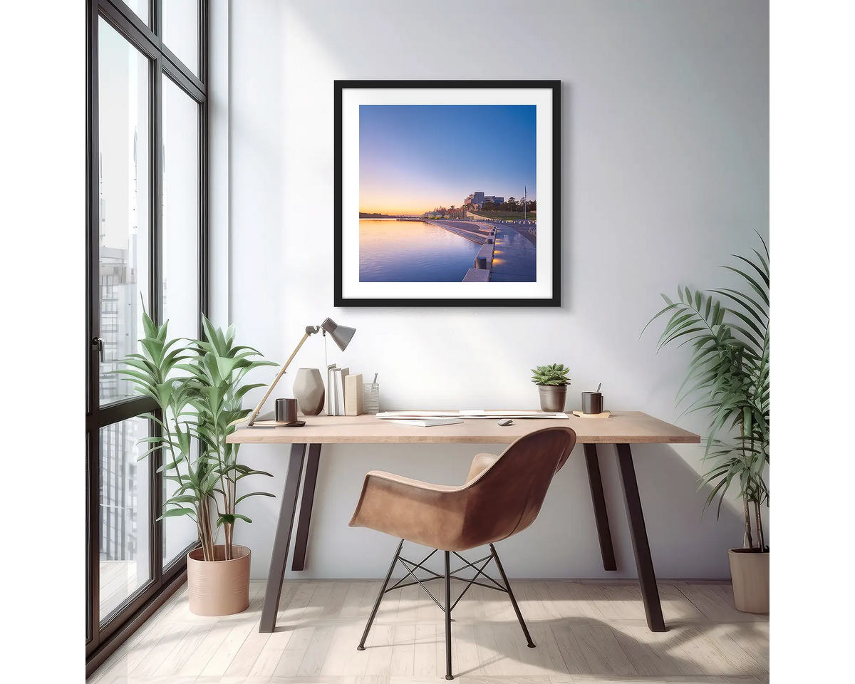 Canberra Awakes. Wall art print of a Canberra sunrise over the high court, with a black frame in a light filled apartment. 