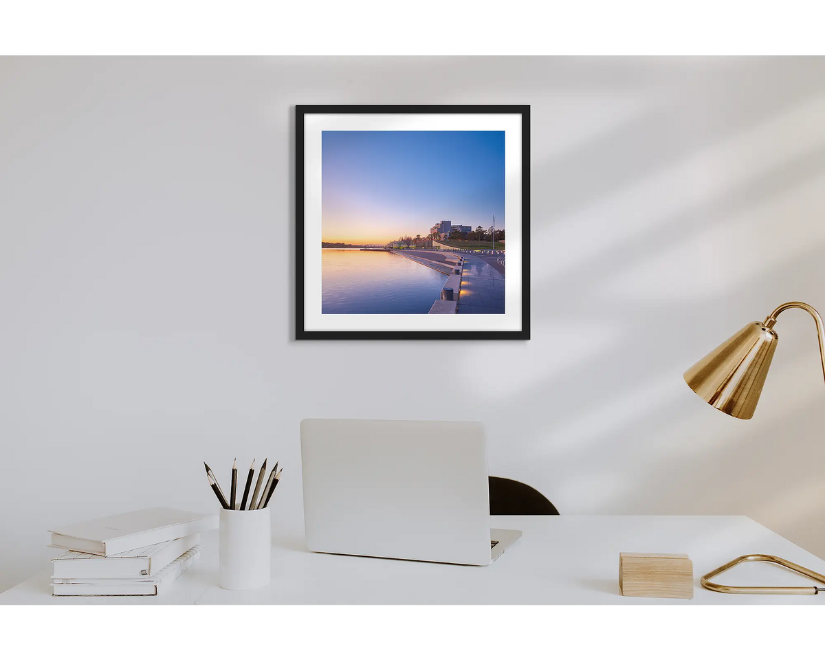 Canberra Awakes. Wall art print of a Canberra sunrise over the HIgh Court with a black frame in a work from home office. 