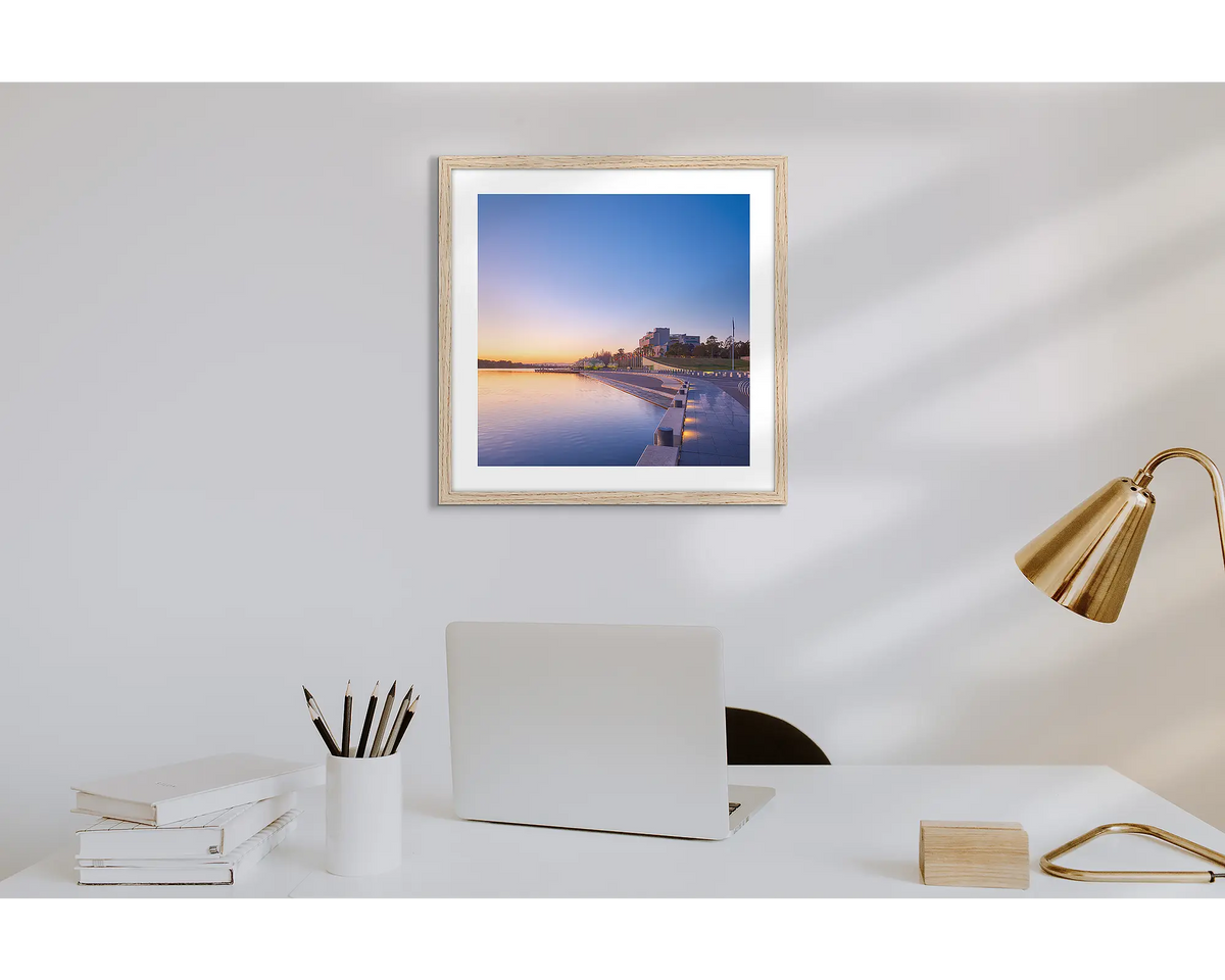 Canberra Awakes. Wall art print of a Canberra sunrise over the HIgh Court with a timber frame in a work from home office. 