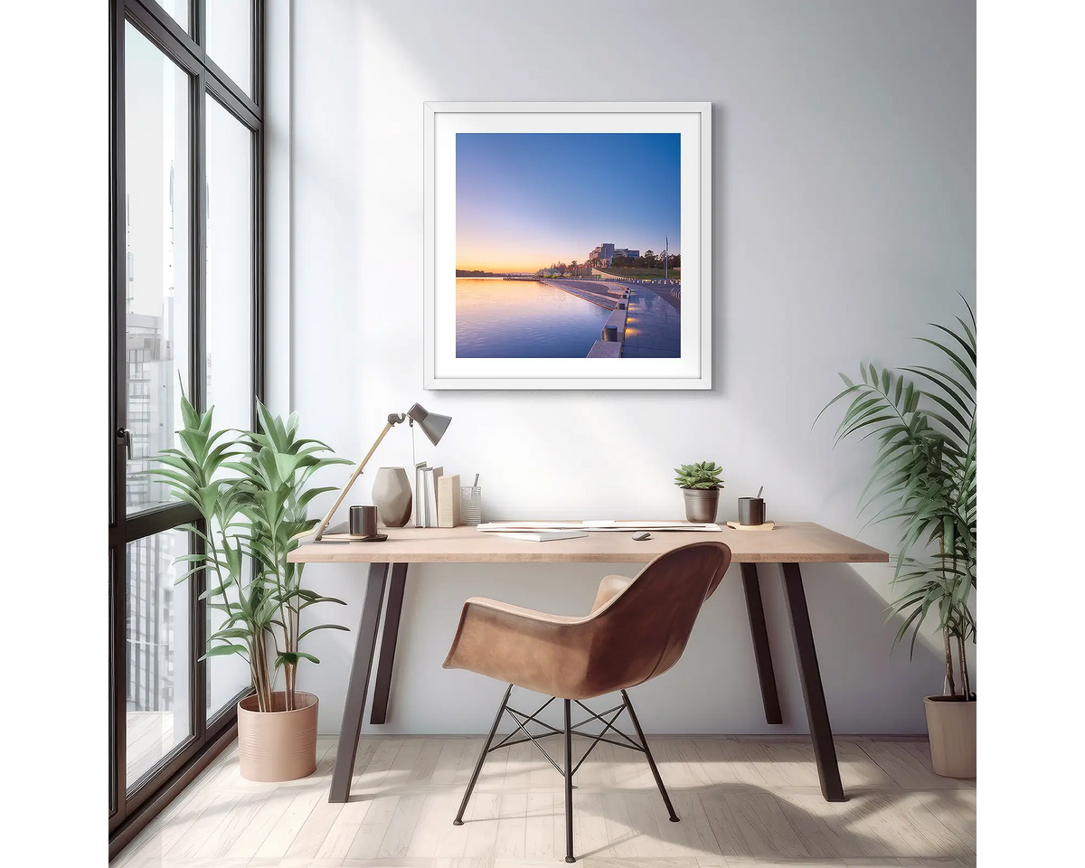 Canberra Awakes. Wall art print of a Canberra sunrise over the high court, with a white frame in a light filled apartment. 
