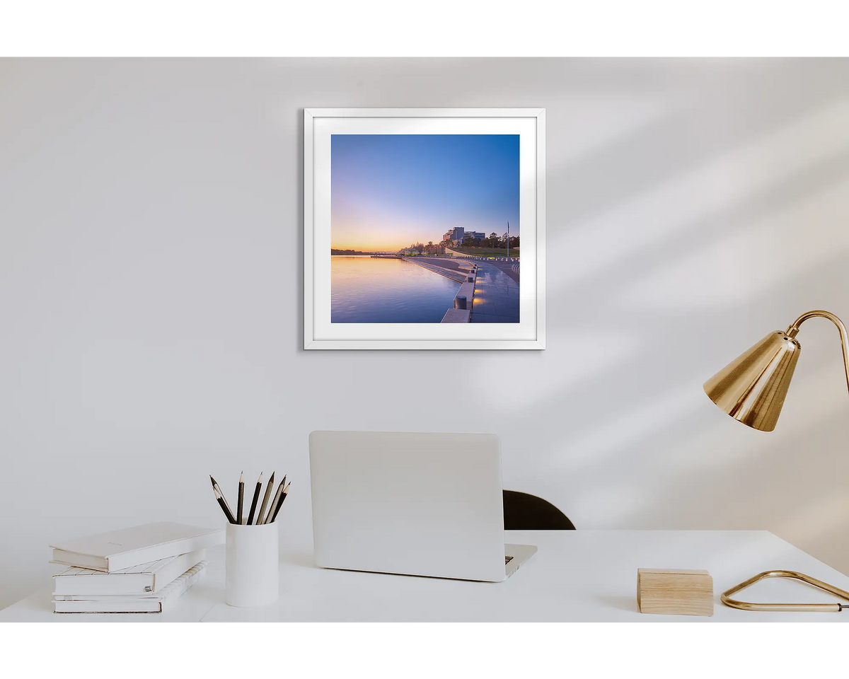 Canberra Awakes. Wall art print of a Canberra sunrise over the HIgh Court with a white frame in a work from home office. 
